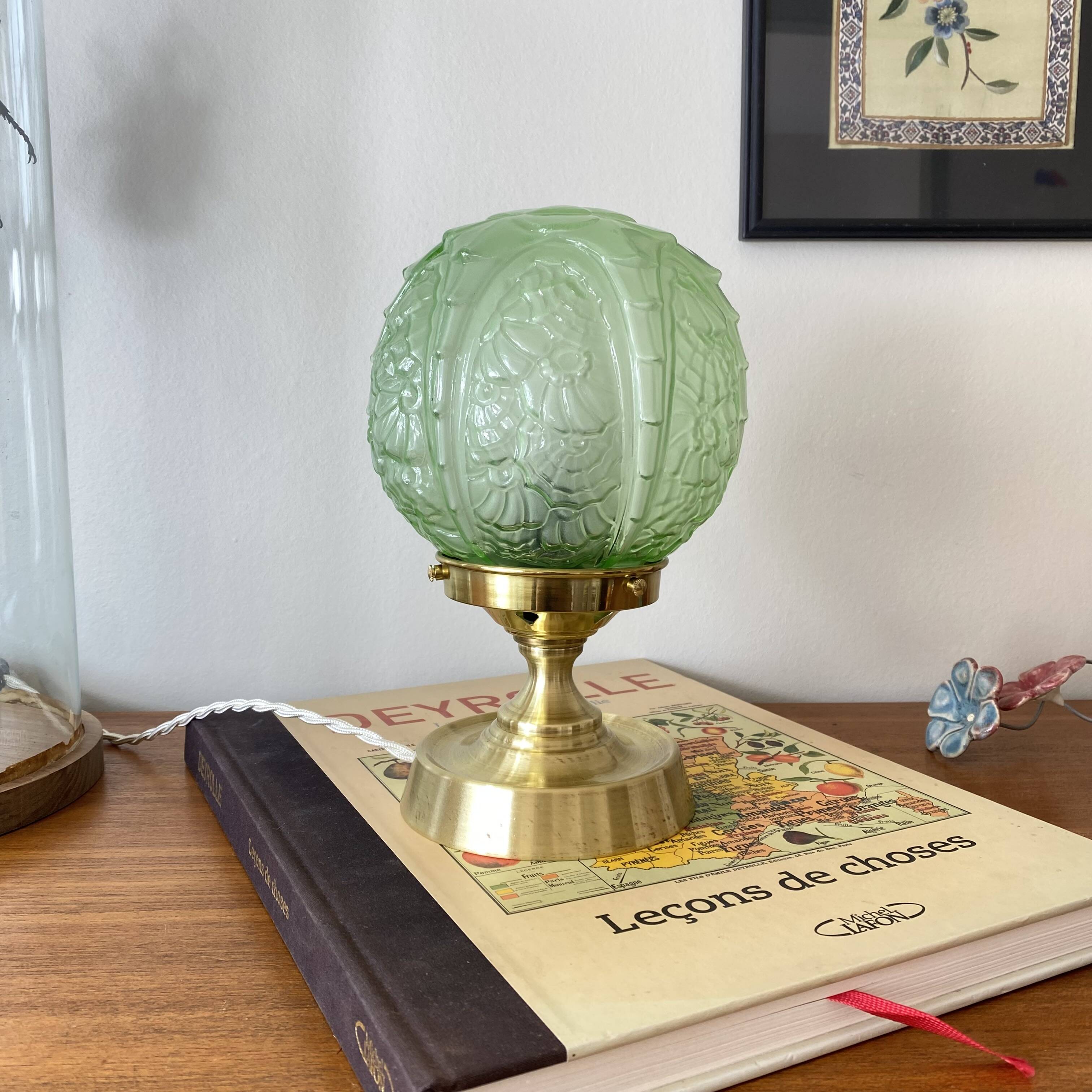 Art Deco green moulded glass globe table lamp with a brass base.