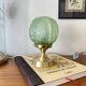 Art Deco green moulded glass globe table lamp with a brass base.