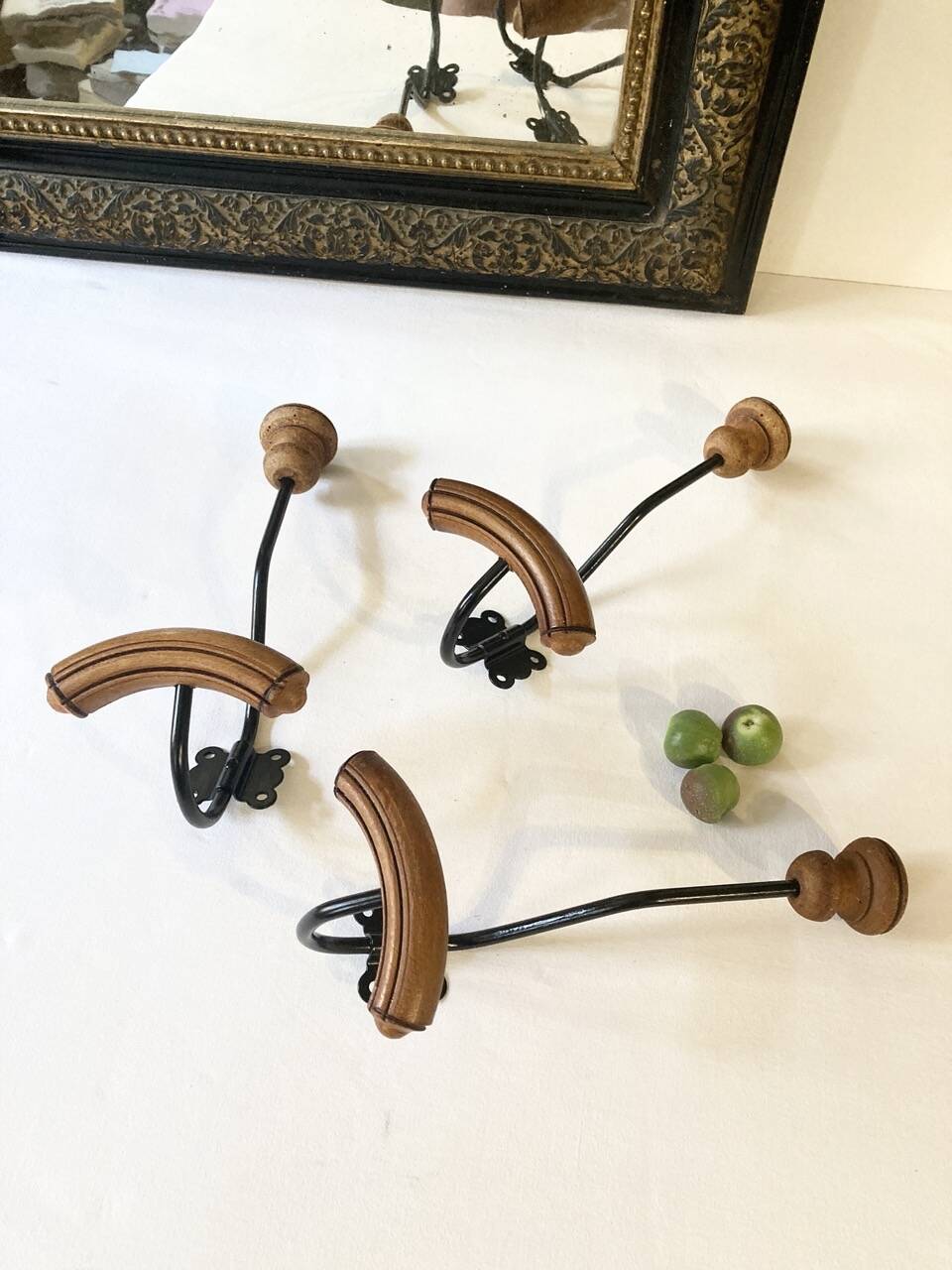 Trio of antique wooden and metal coat hooks