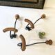 Trio of antique wooden and metal coat hooks