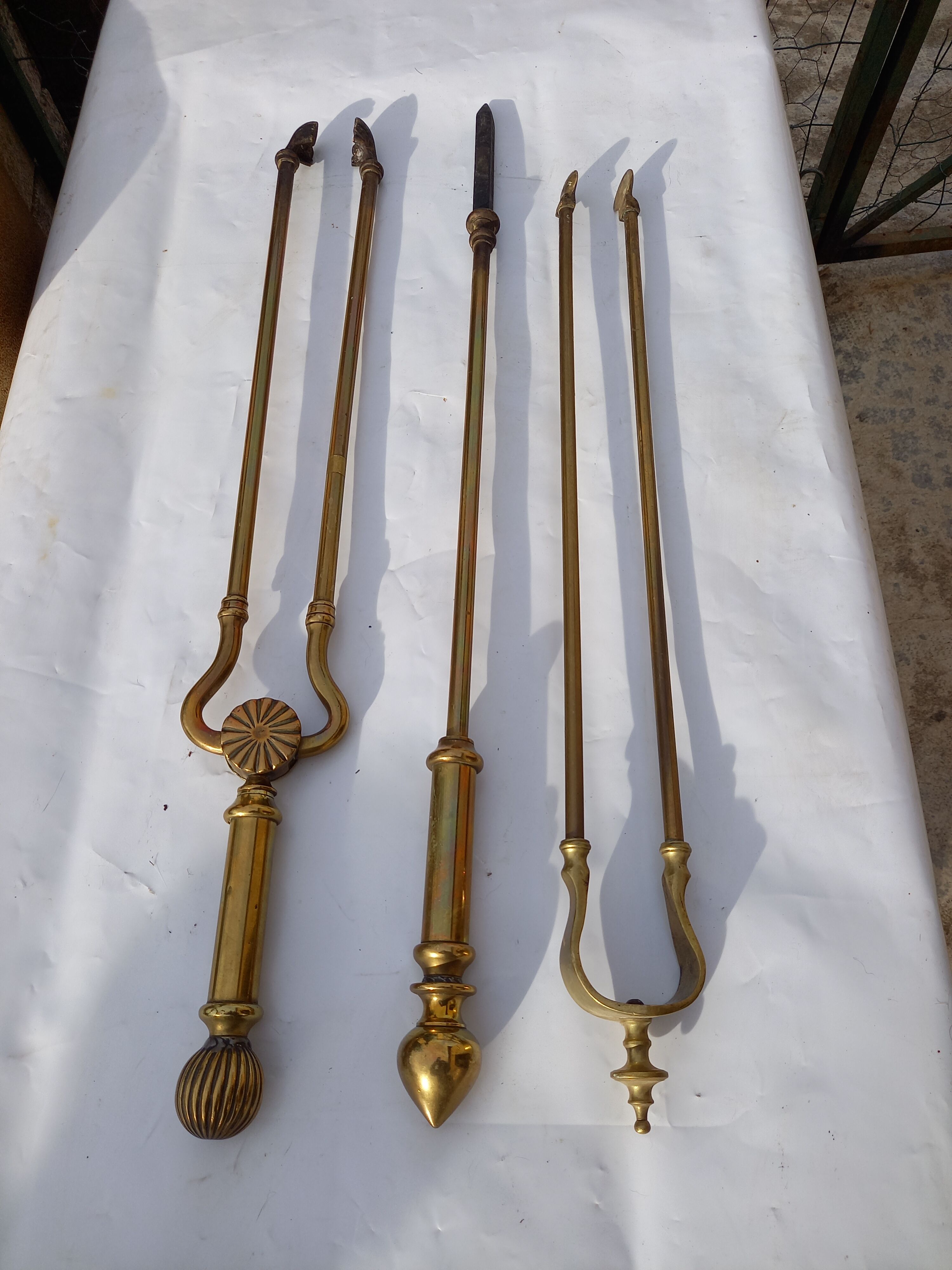 Mismatched set of chimney accessories two pliers and a fire pier