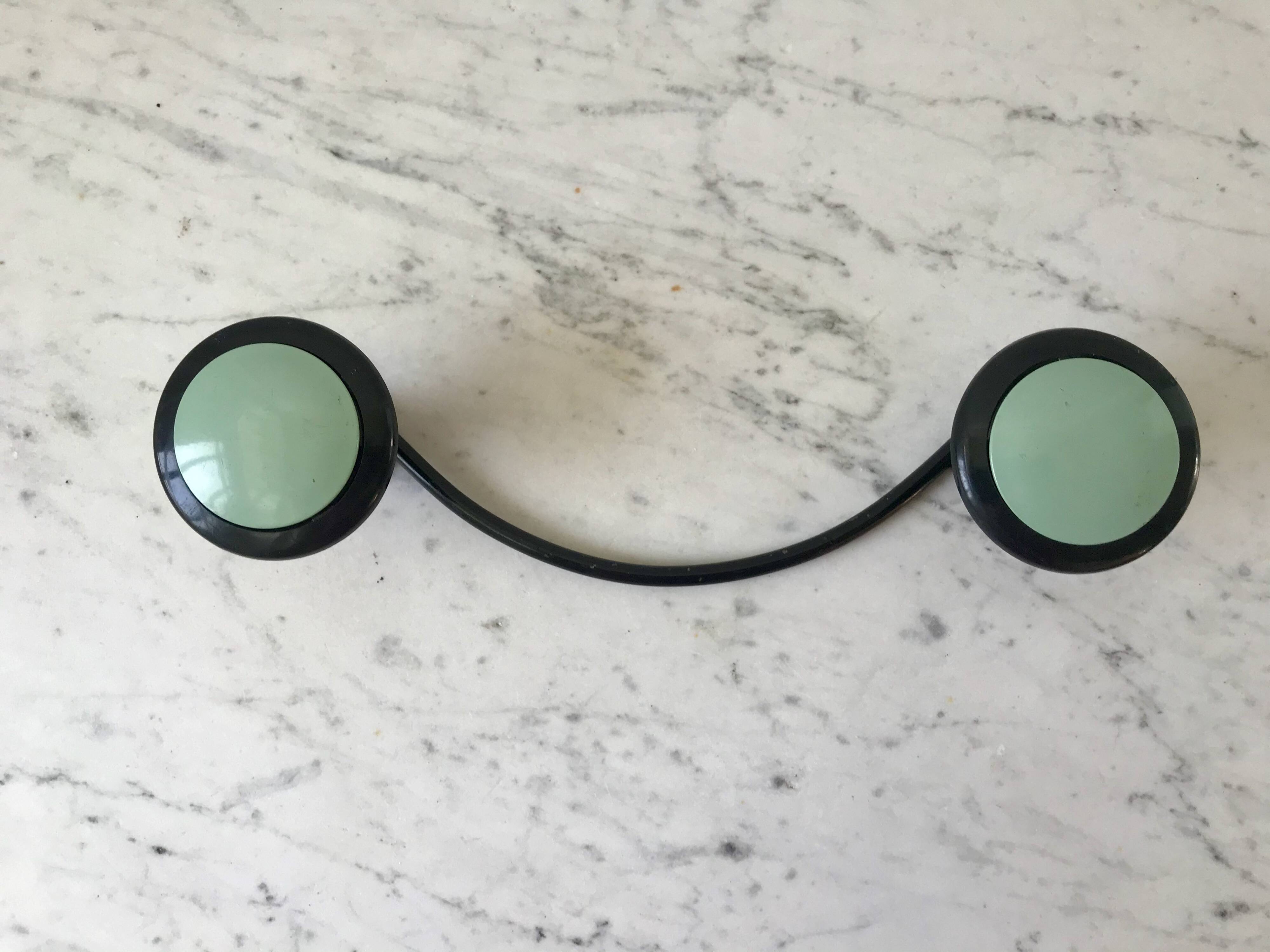 Design coat hook in sage green and black metal from the 70s