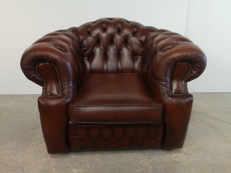 Curved brown leather chesterfield armchair