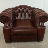 Curved brown leather chesterfield armchair