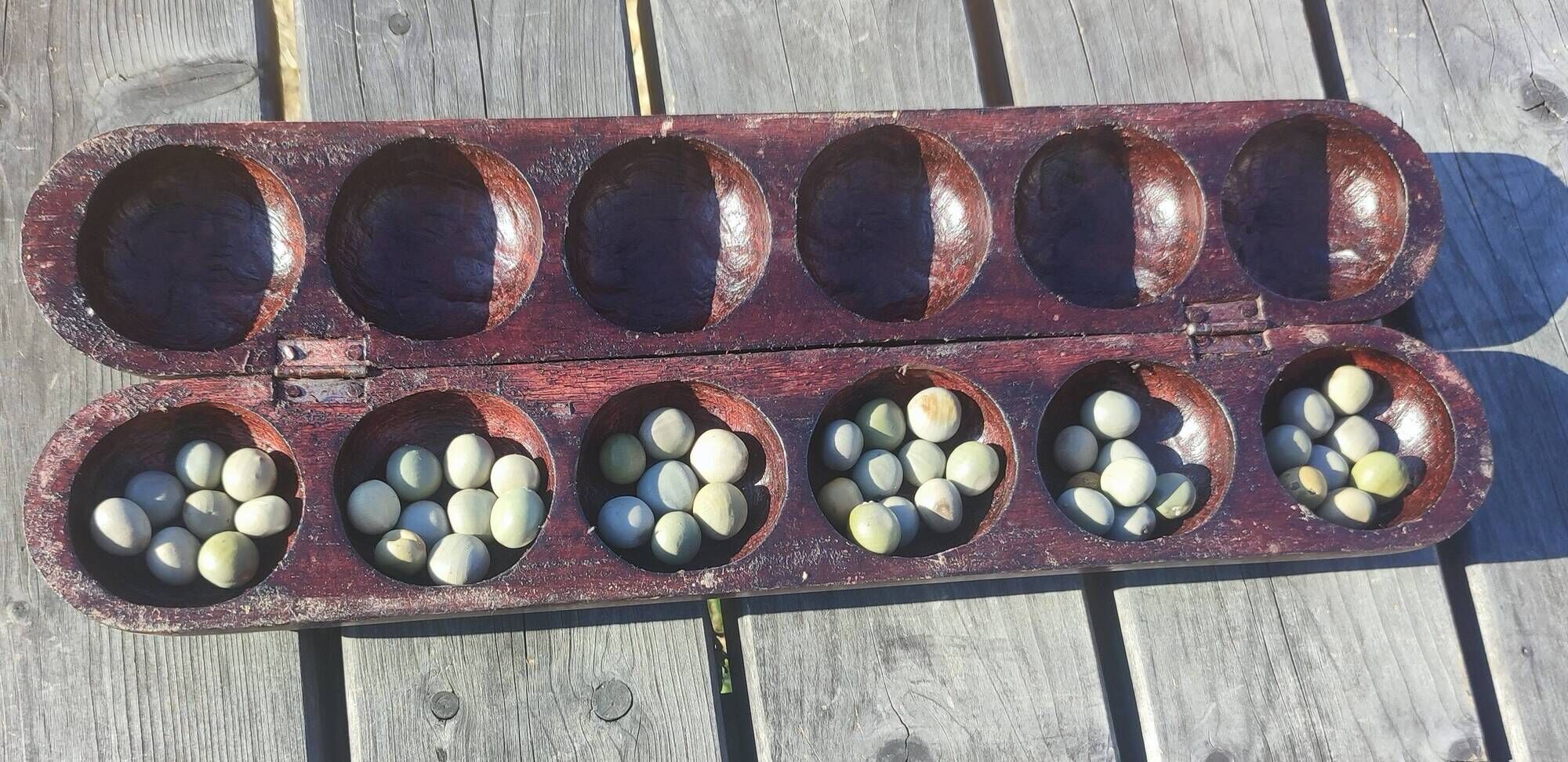 Traditional carved wooden Awalé game Mancala