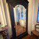 Black wardrobe with a mirrored door in ebony finish.