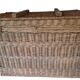 Wicker travel trunk XIX with metal clasps and handles.