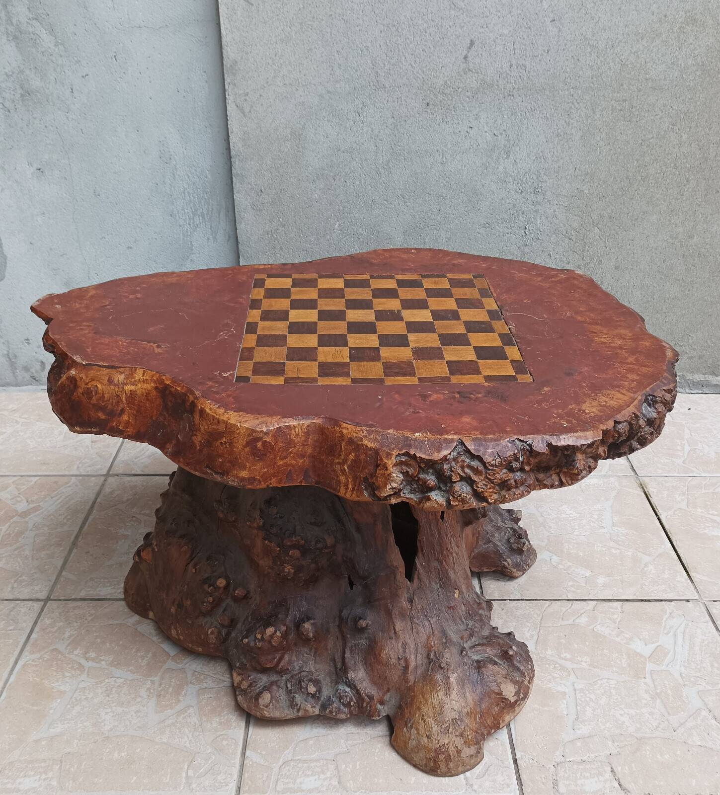 Brutalist chessboard coffee table made from tree stump.