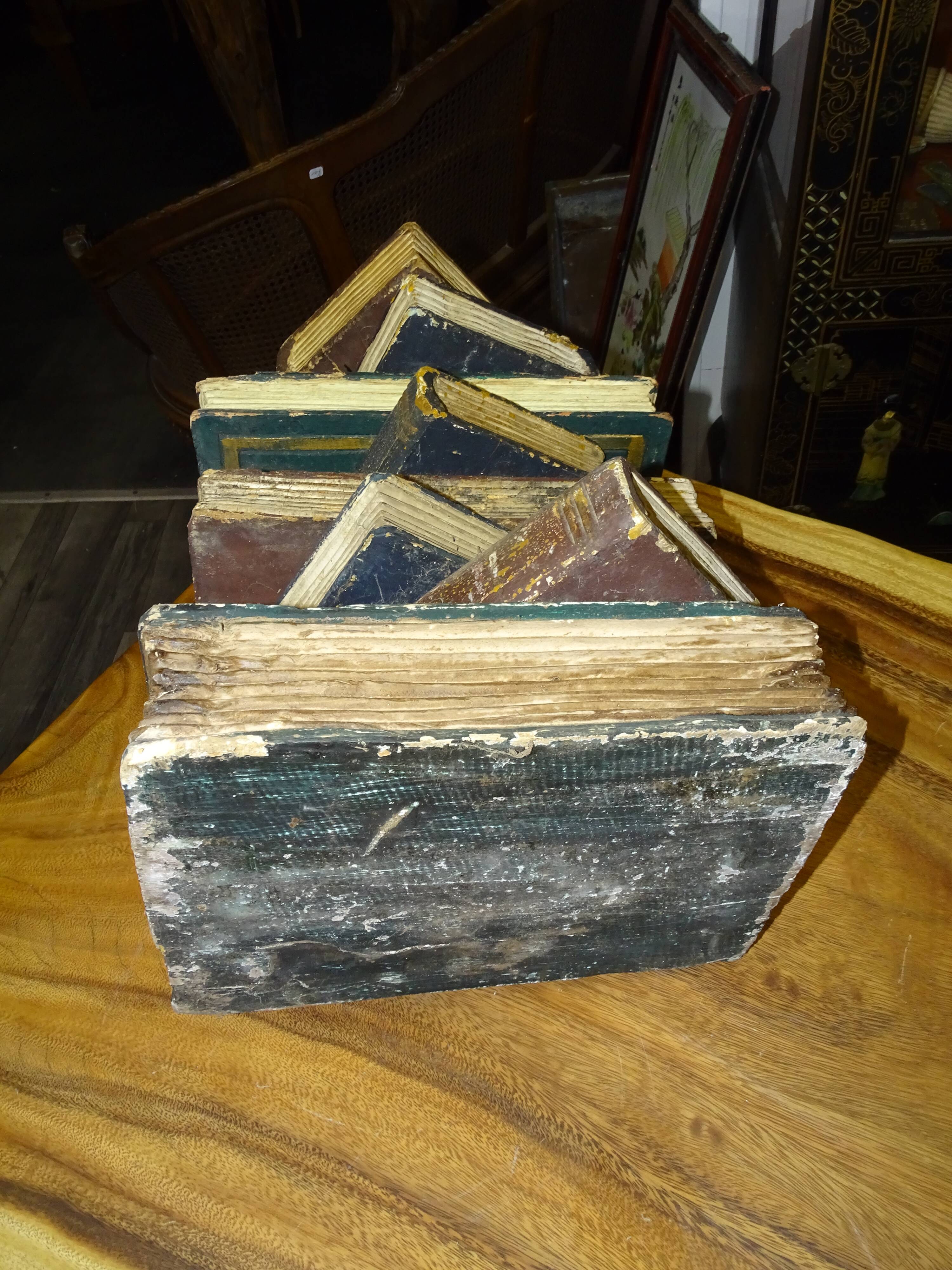 side table, end of sofa stack of wooden books, old, beautiful patina