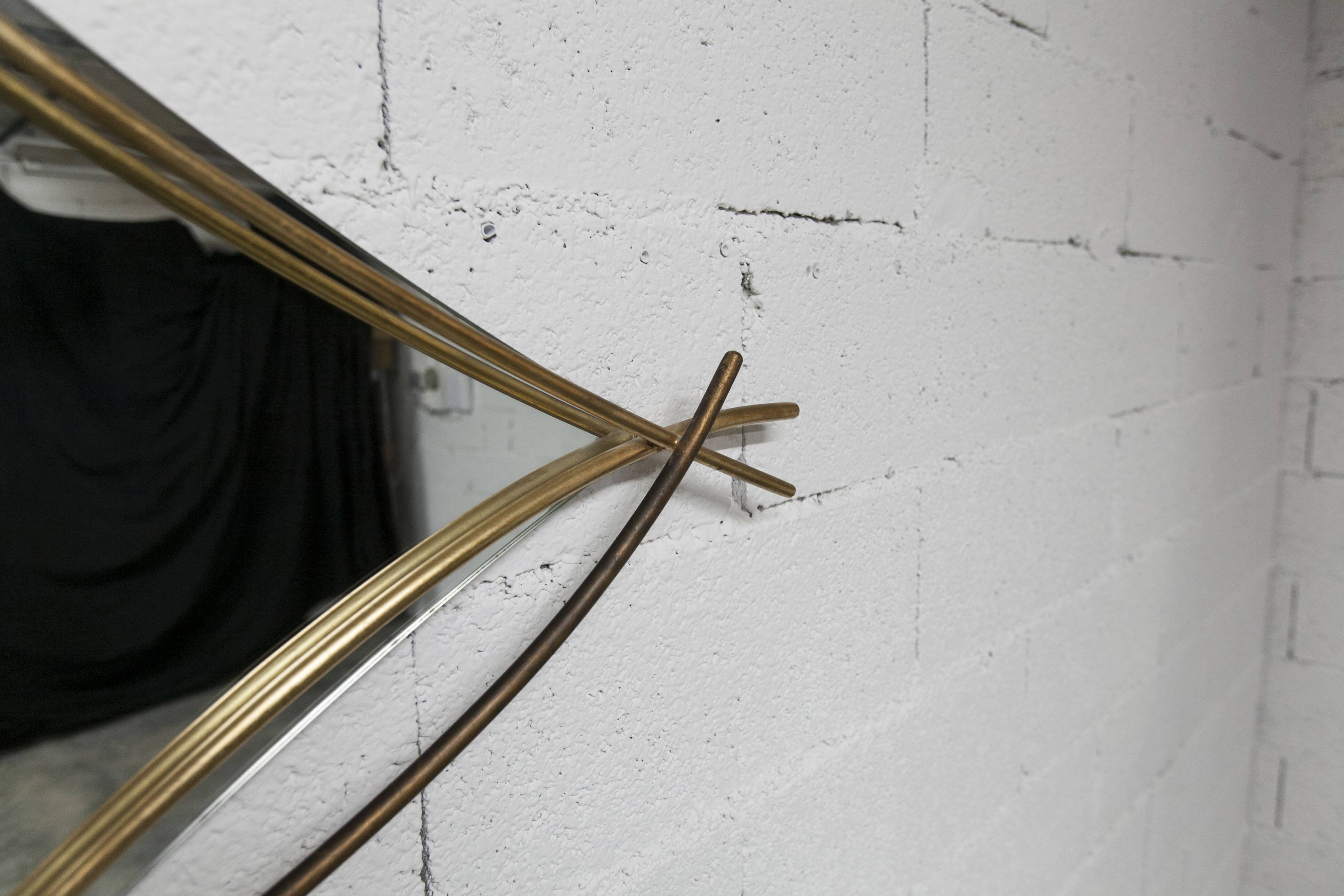 Sculptural mirror with two-tone gilded arches, France, 1970s, 95 x 133 cm