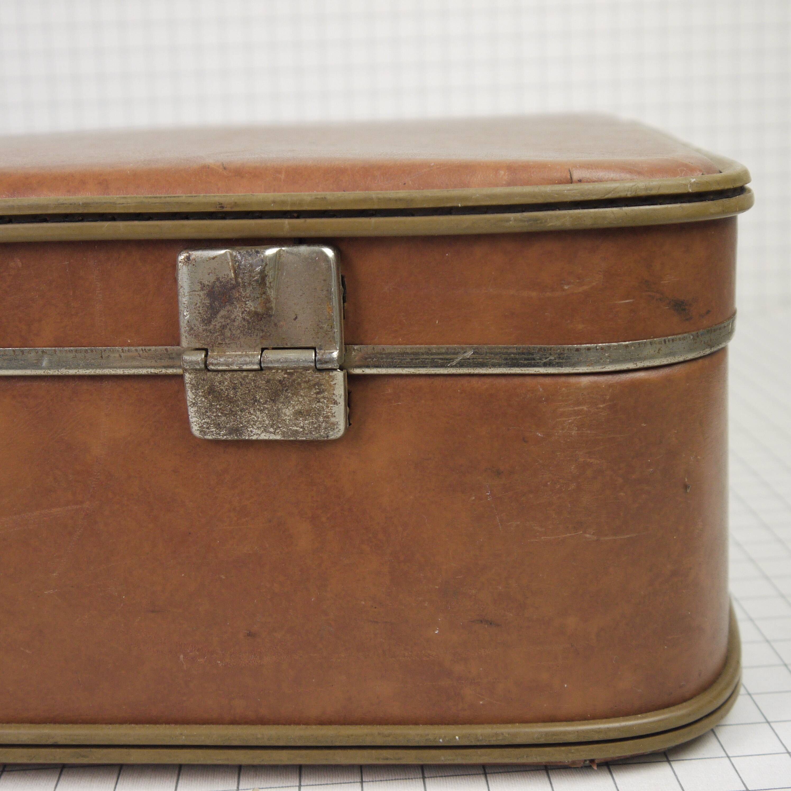 Cardboard and brown leather case