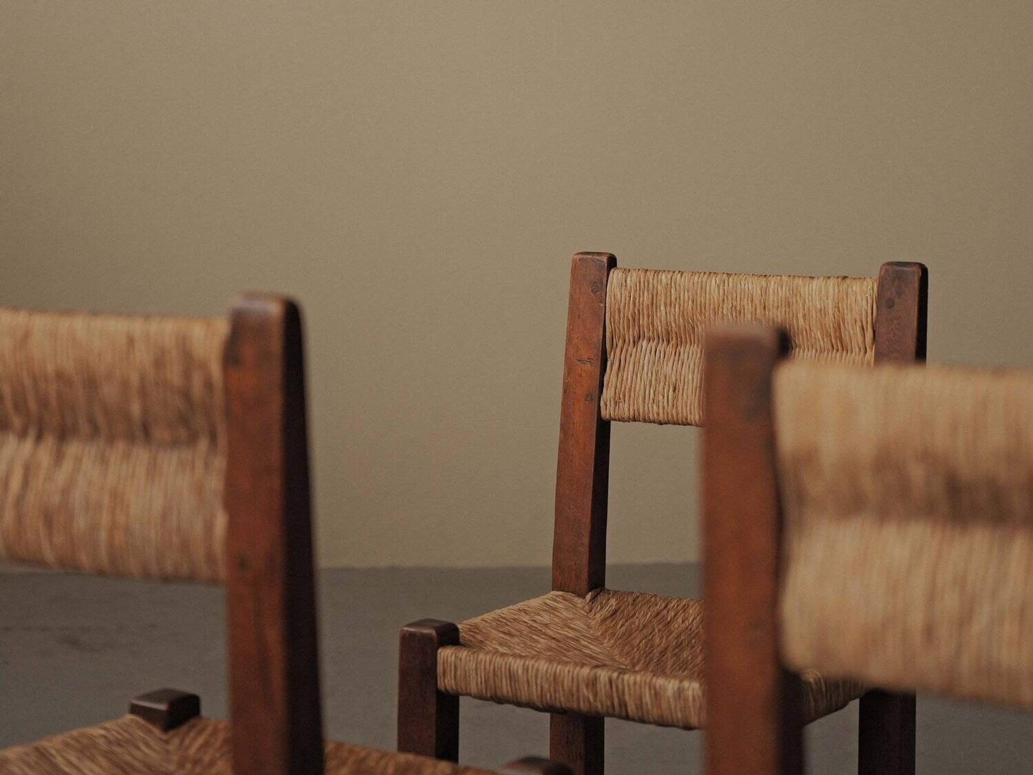 Set of four modernist chairs in oak and straw, France, circa 1960.
