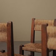 Set of four modernist chairs in oak and straw, France, circa 1960.