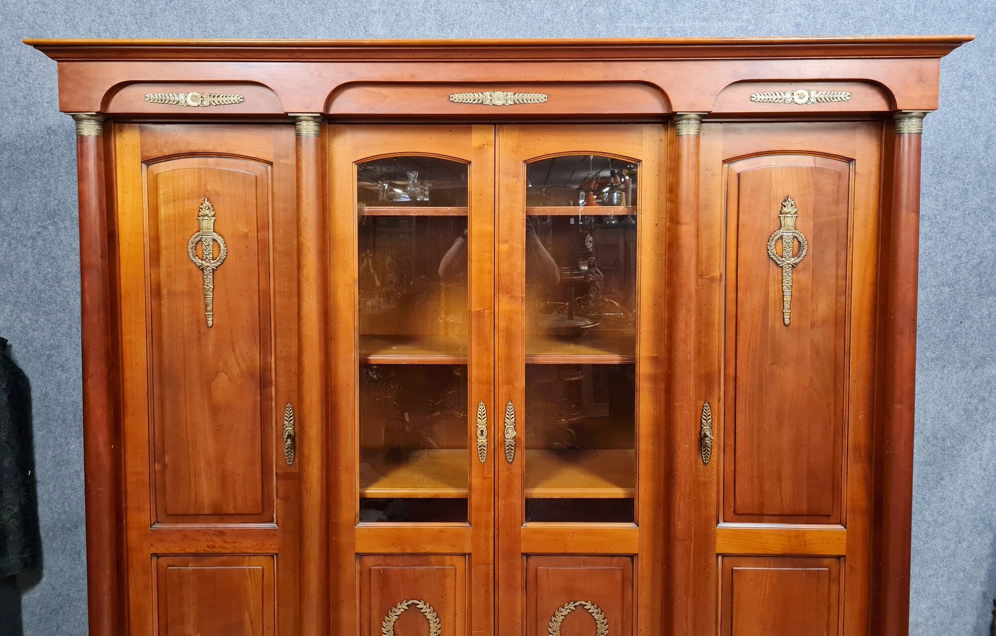 Empire library in cherry tree with blonde patina and gilded bronze around 1950