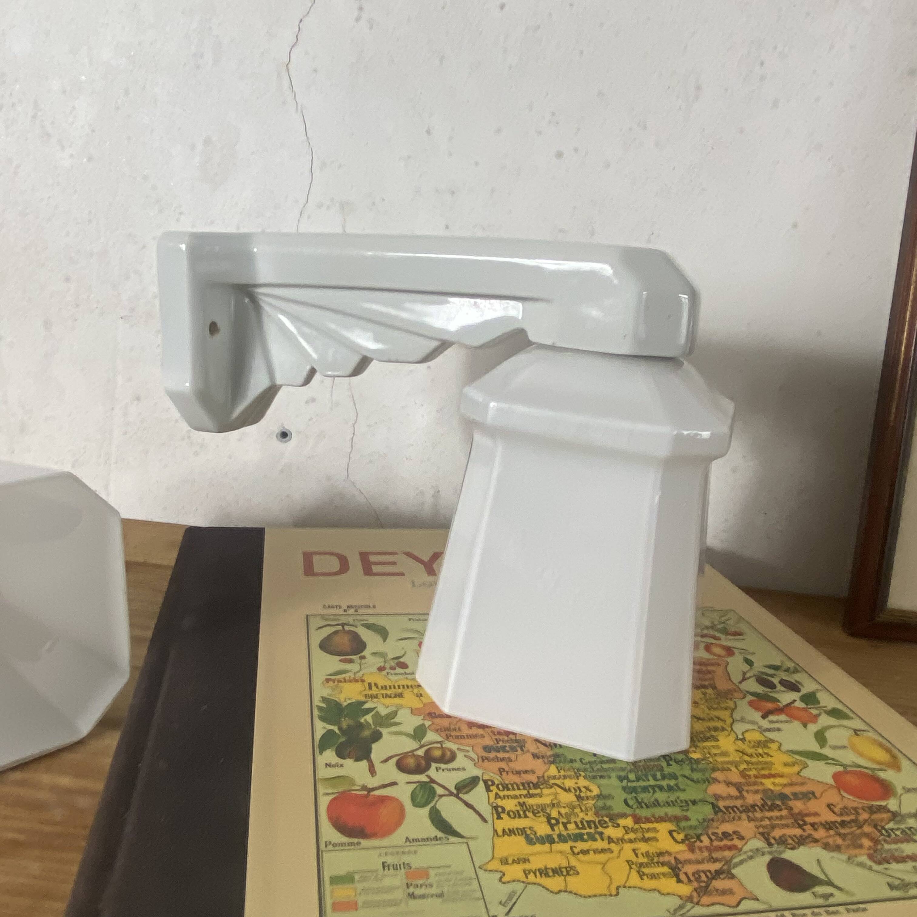 Pair of Art Deco wall sconces in ceramic with opaline glass shades.