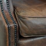 Vintage wingback armchair made of sheepskin leather with beautiful colours