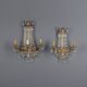 Antique wall sconces in gilded bronze with neoclassical motifs, 20th century.