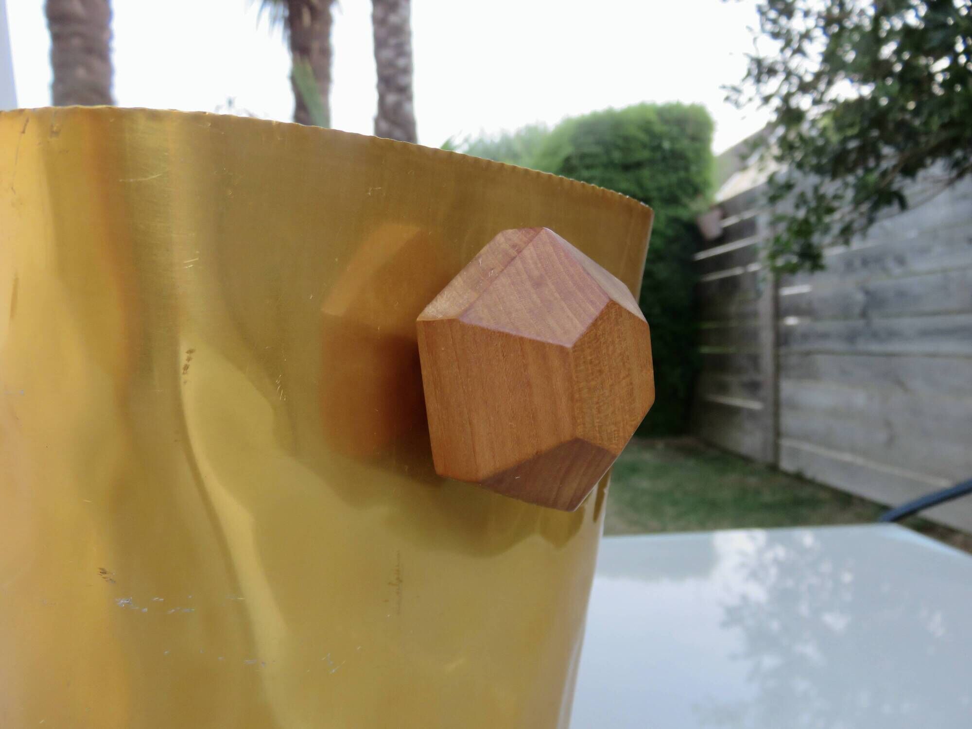 Gold anodised aluminium ice bucket, teak handles, signed T.L PARIS.