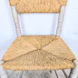 Rustic chair made of turned wood and straw.