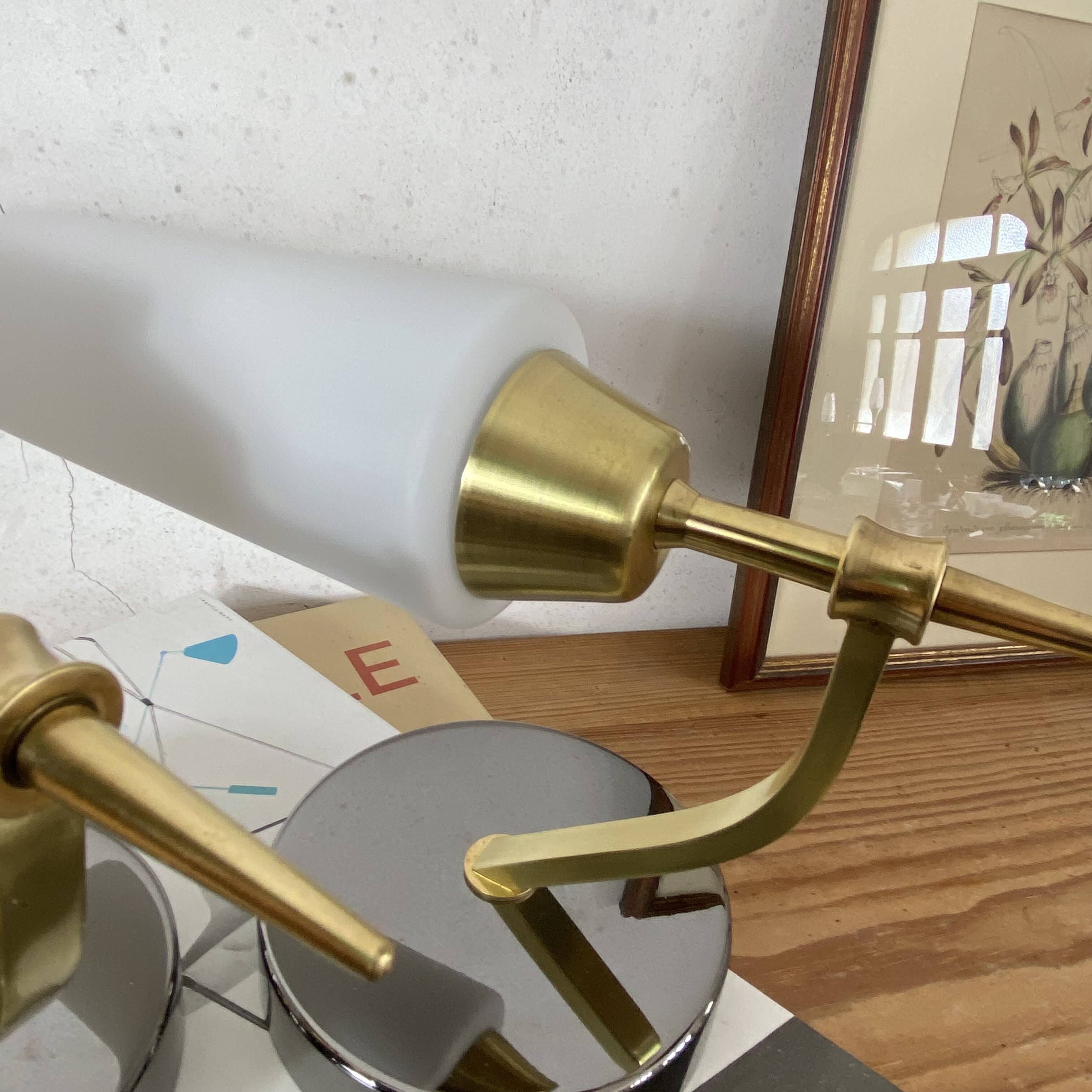 Pair of wall sconces in brass with white glass tulips.