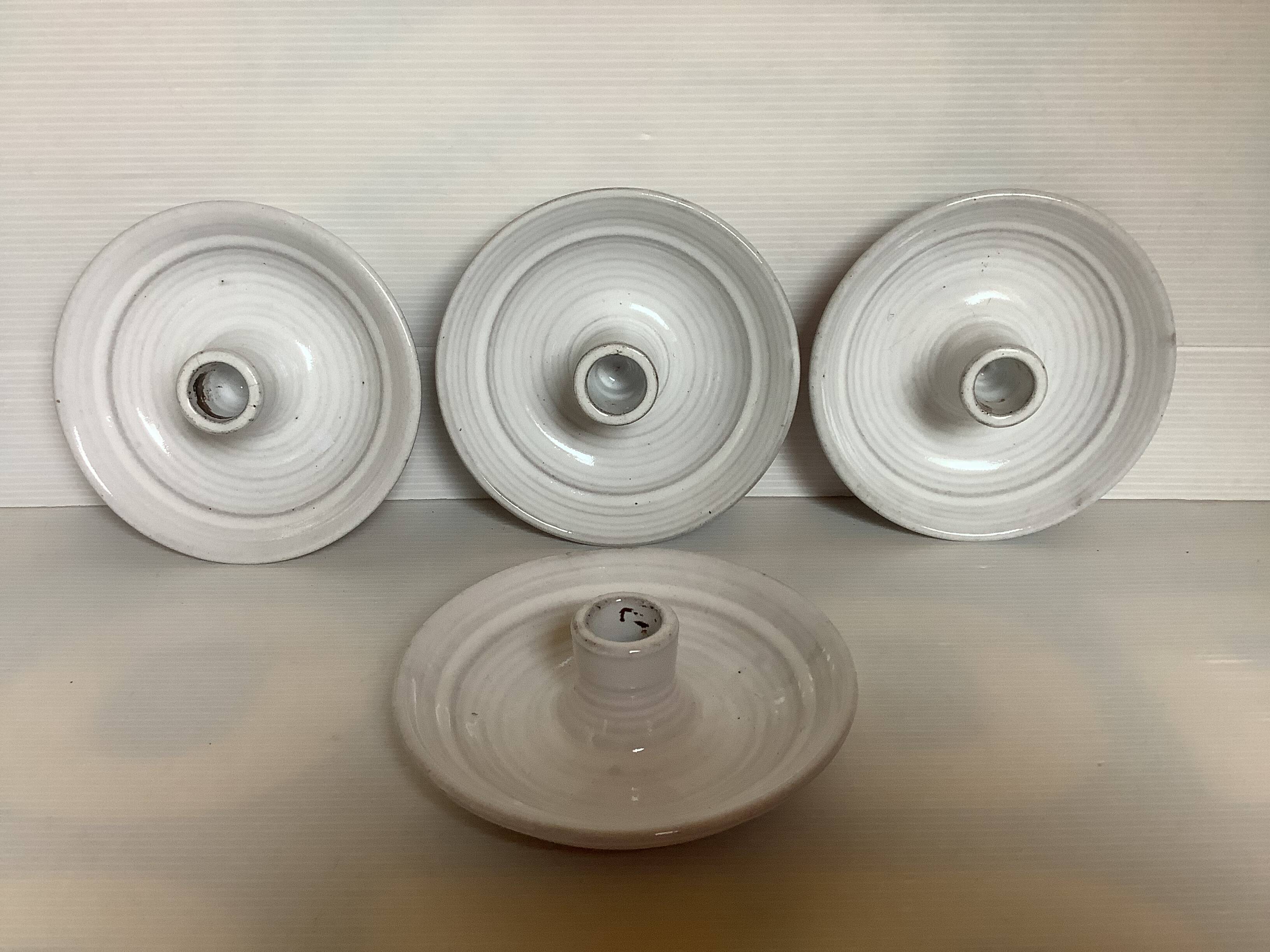 Four ceramic candle holders