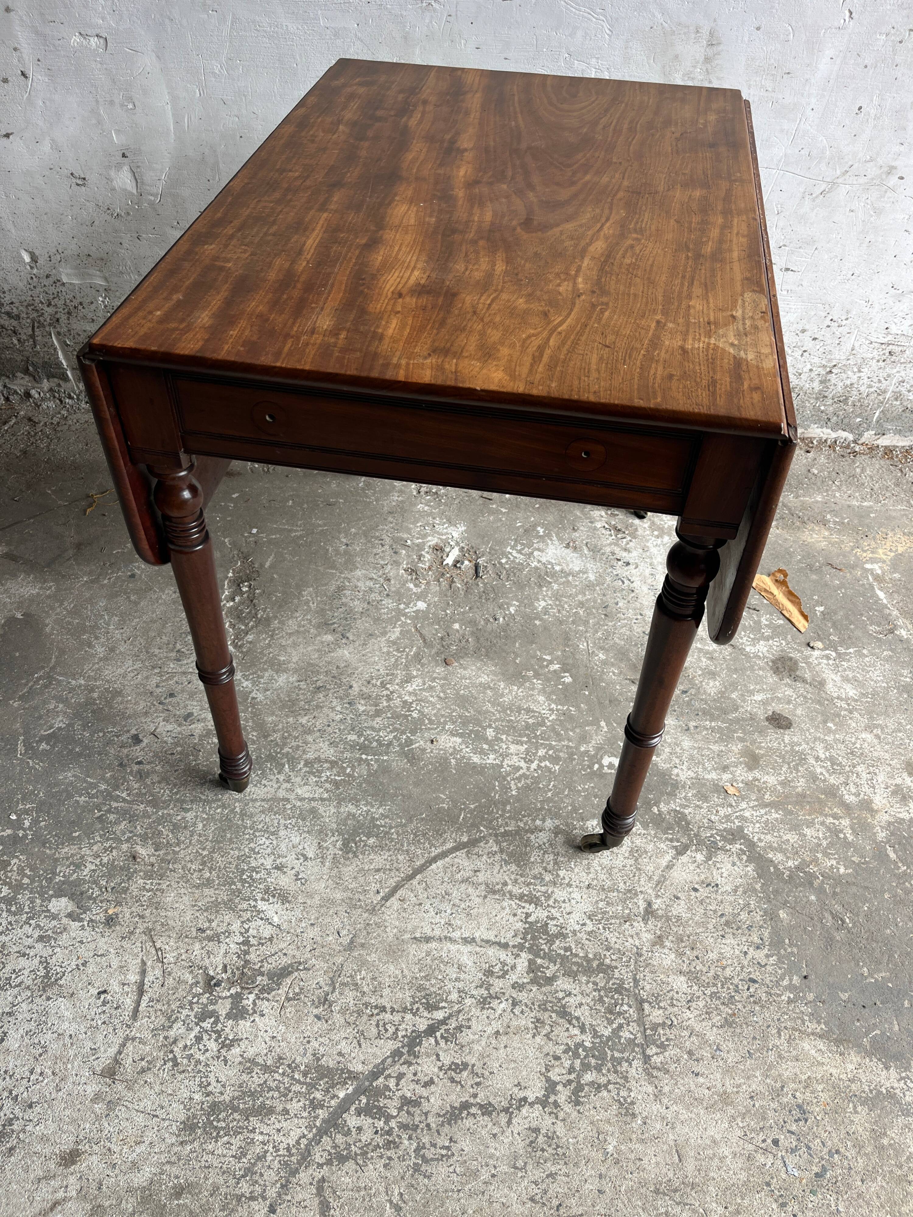 Antique drop-leaf side table on wheels