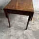 Antique drop-leaf side table on wheels