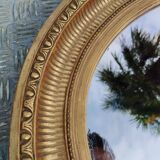 Antique oval mirror in gilded stucco with gold leaf, 19th century
