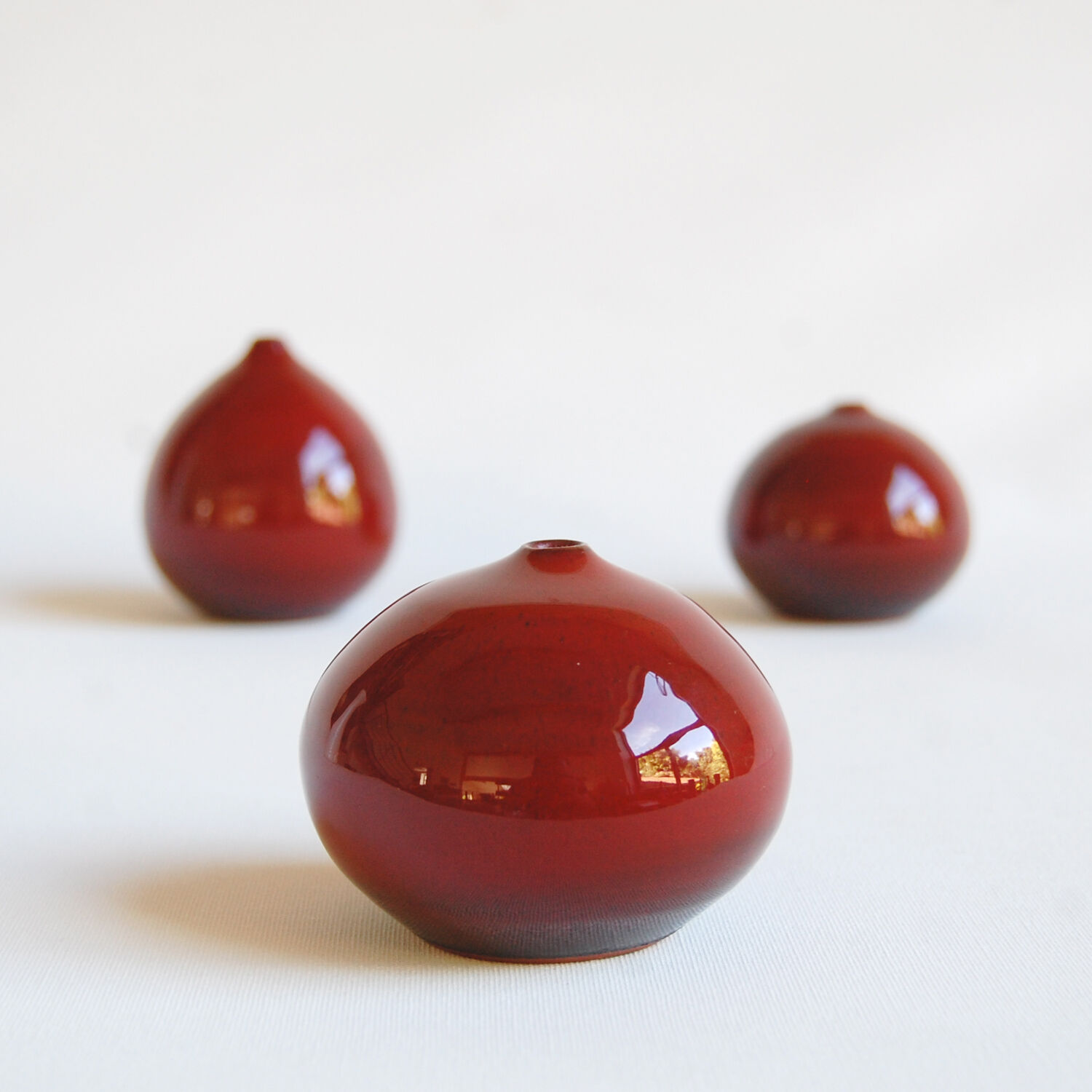 Trio of red miniature ceramics by Antonio Lampecco