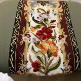 Vintage upholstered footstool, floral decor in Aubusson style.