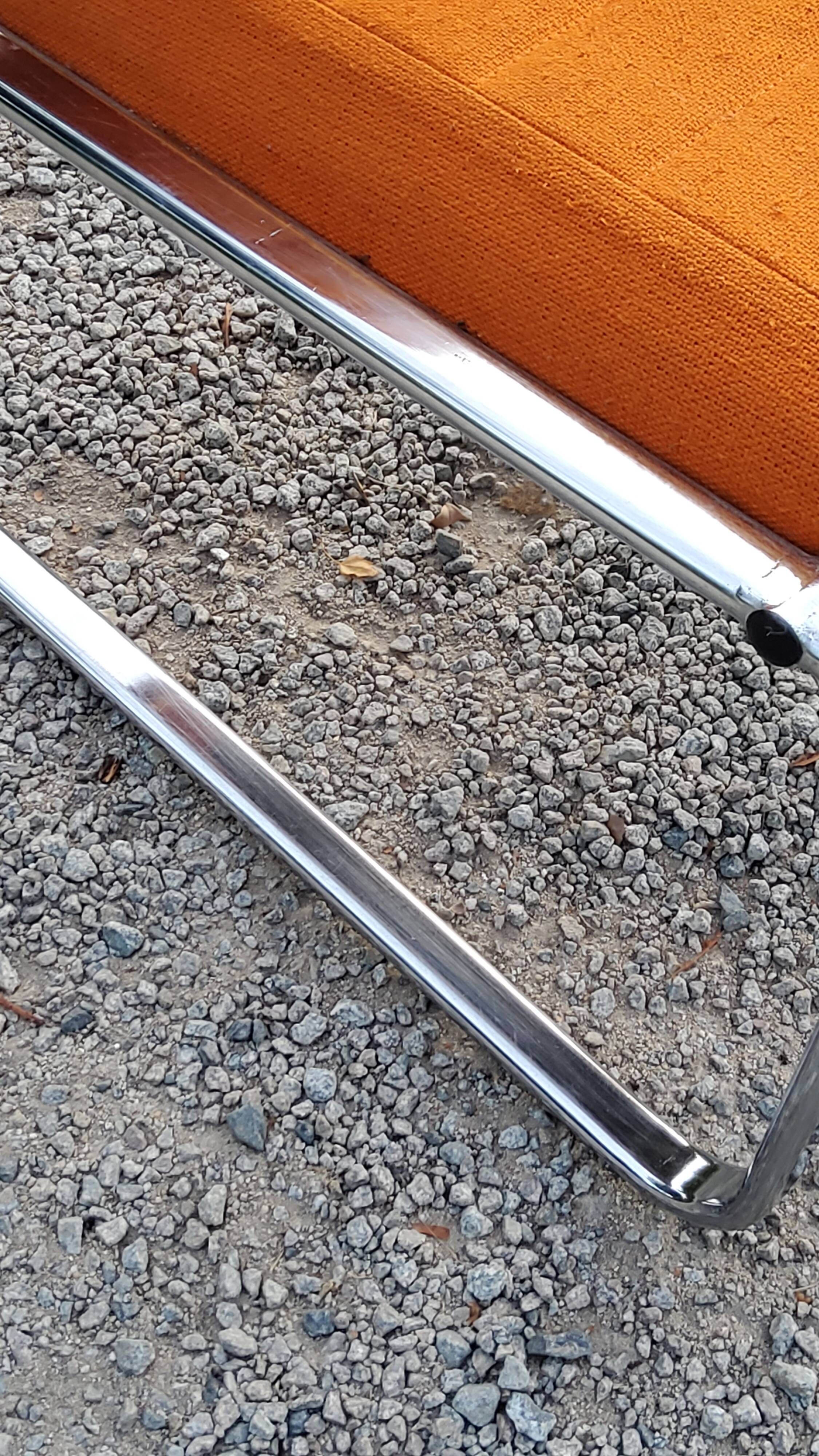 Pair of designer armchairs in orange fabrics and chrome tubes from the 70s