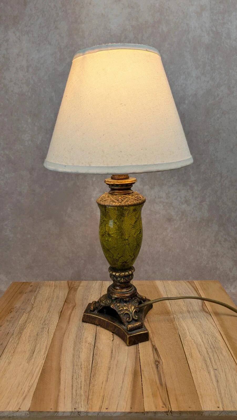 Vintage lamp with bronze imitation base & green relief glass in an antique style.