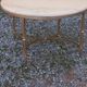 Round neoclassical coffee table with a marble top and golden metal base.