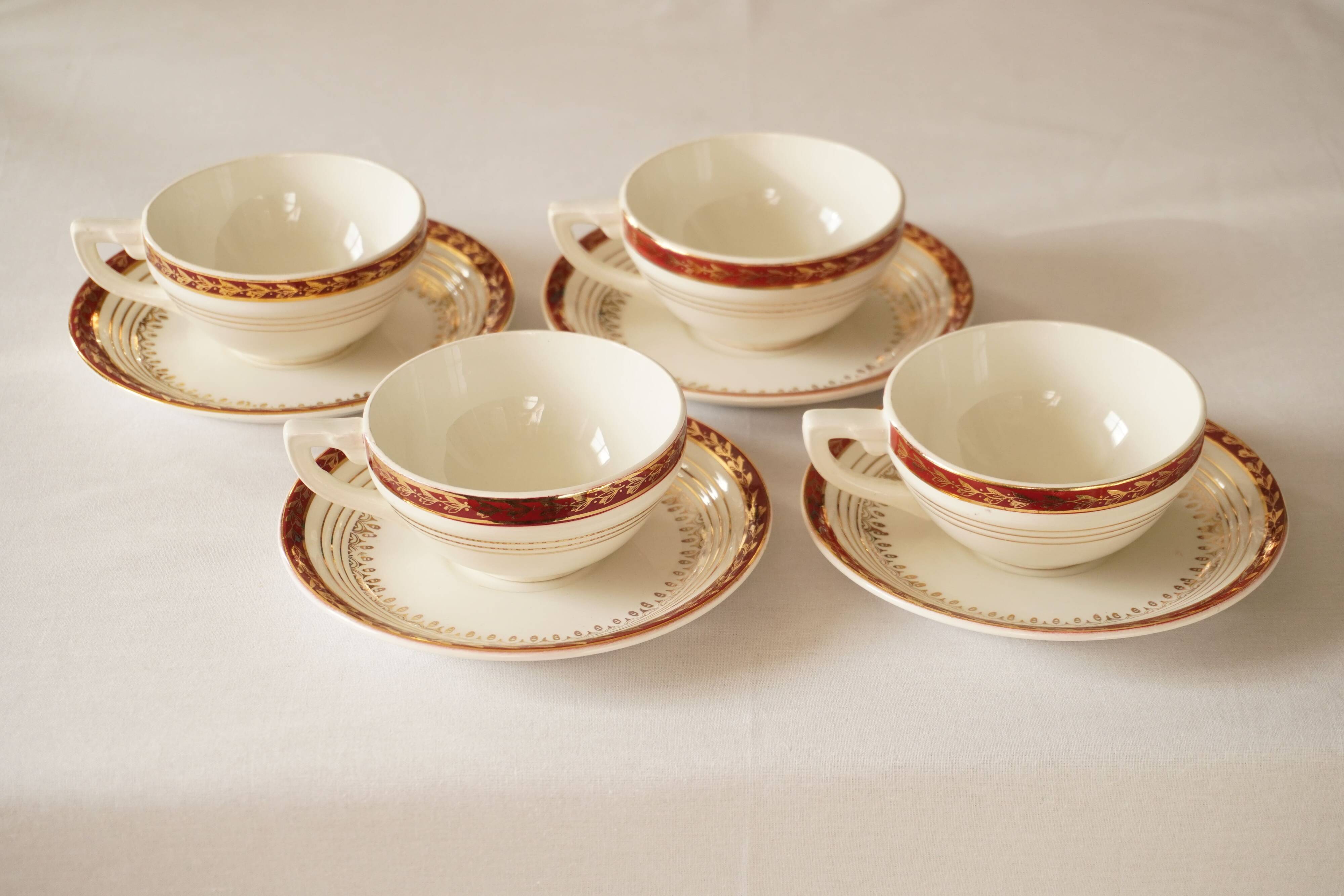 Set of 4 white, red and gold porcelain teacups, Ceranord