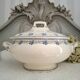 Antique mismatched earthenware soup plates with a tureen