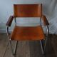 Trois fauteuils en cuir