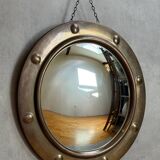 50s French porthole-style witch mirror with convex glass.
