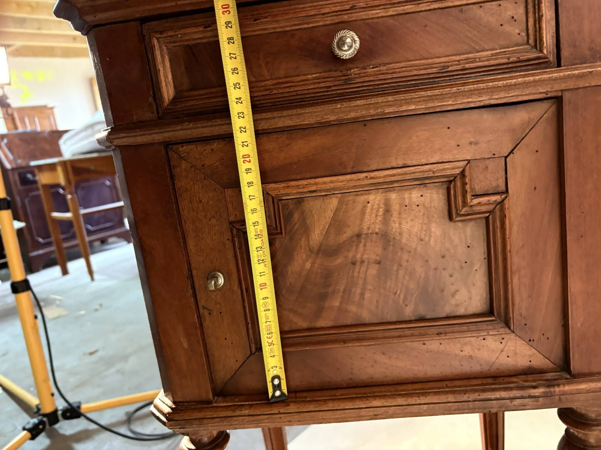 Antique wooden bedside table with turned legs.