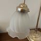 Articulated brass lamp with glass shade, early 20th century.