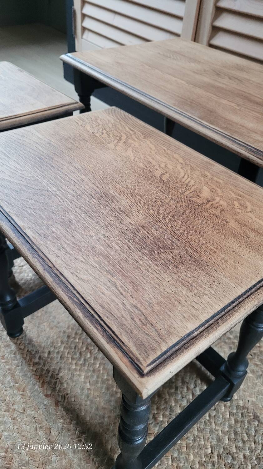 Nest tables in wood and black.