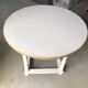 Antique round table refurbished in cerused white, with twisted legs.