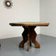 Round table in solid wood, thick top, vintage brutalist style from the 1960s.