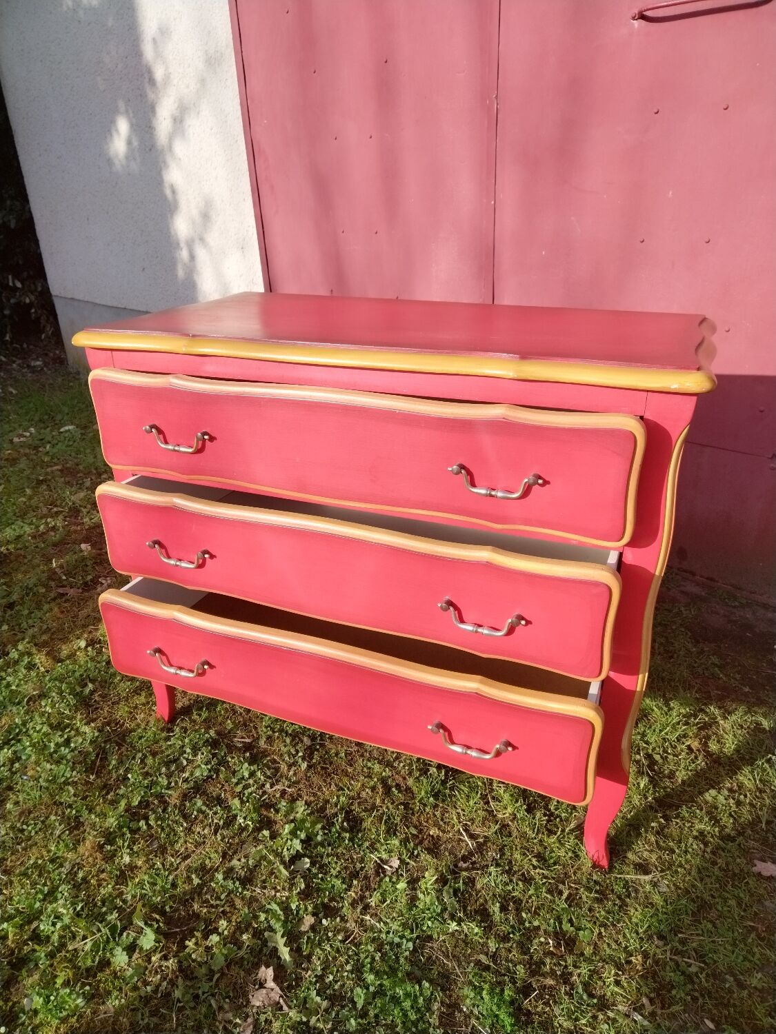 Matte gold and red patinated chest of drawers