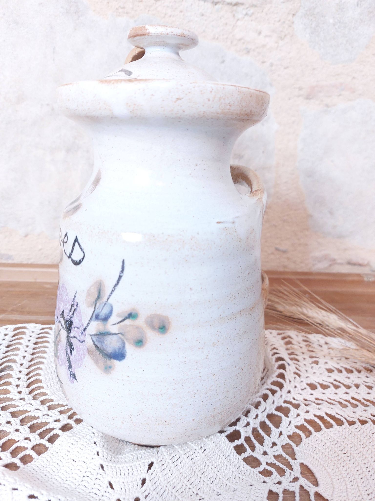 Old large vintage stoneware olive pot with its wooden spoon