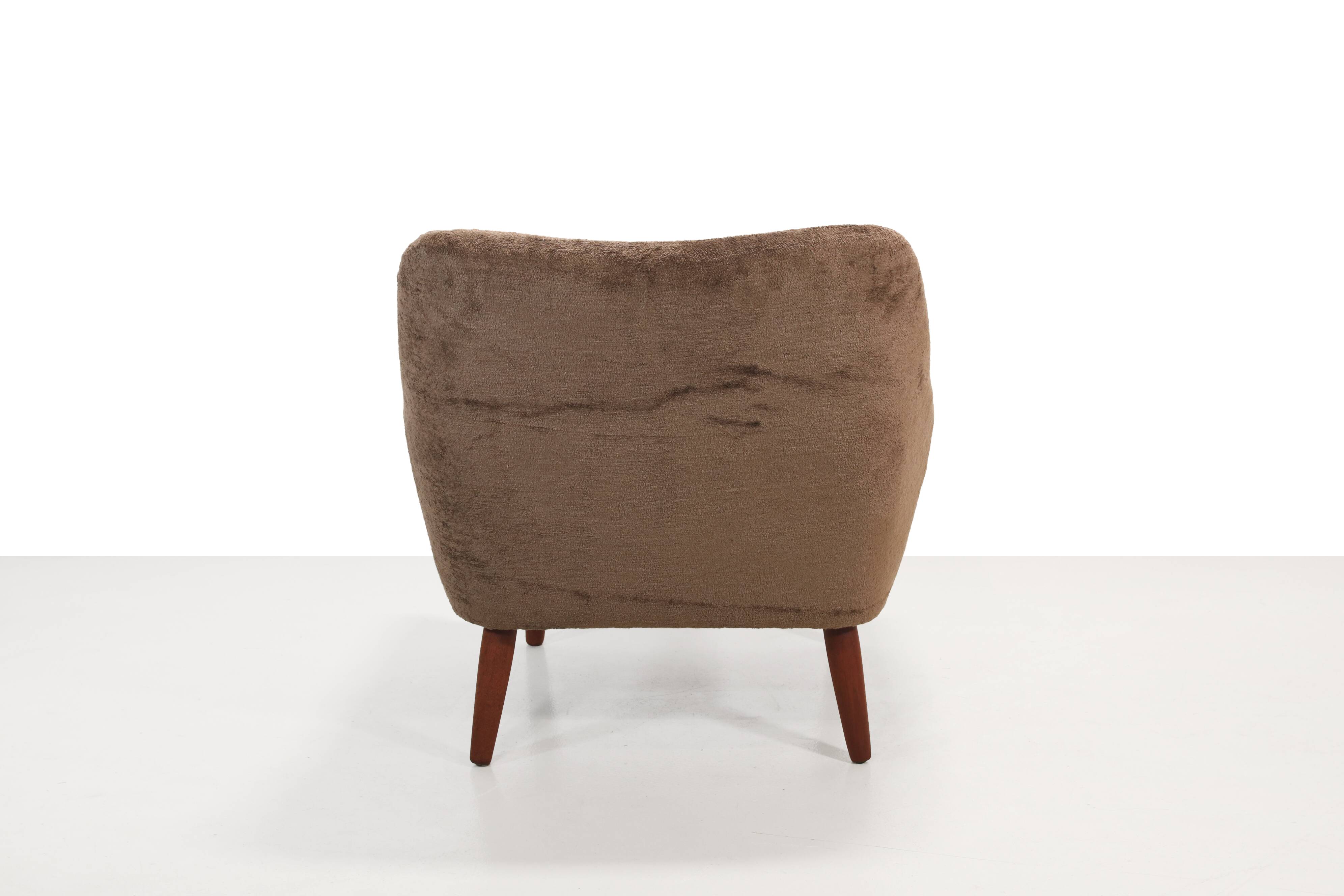 Danish design armchair in brown faux sheepskin