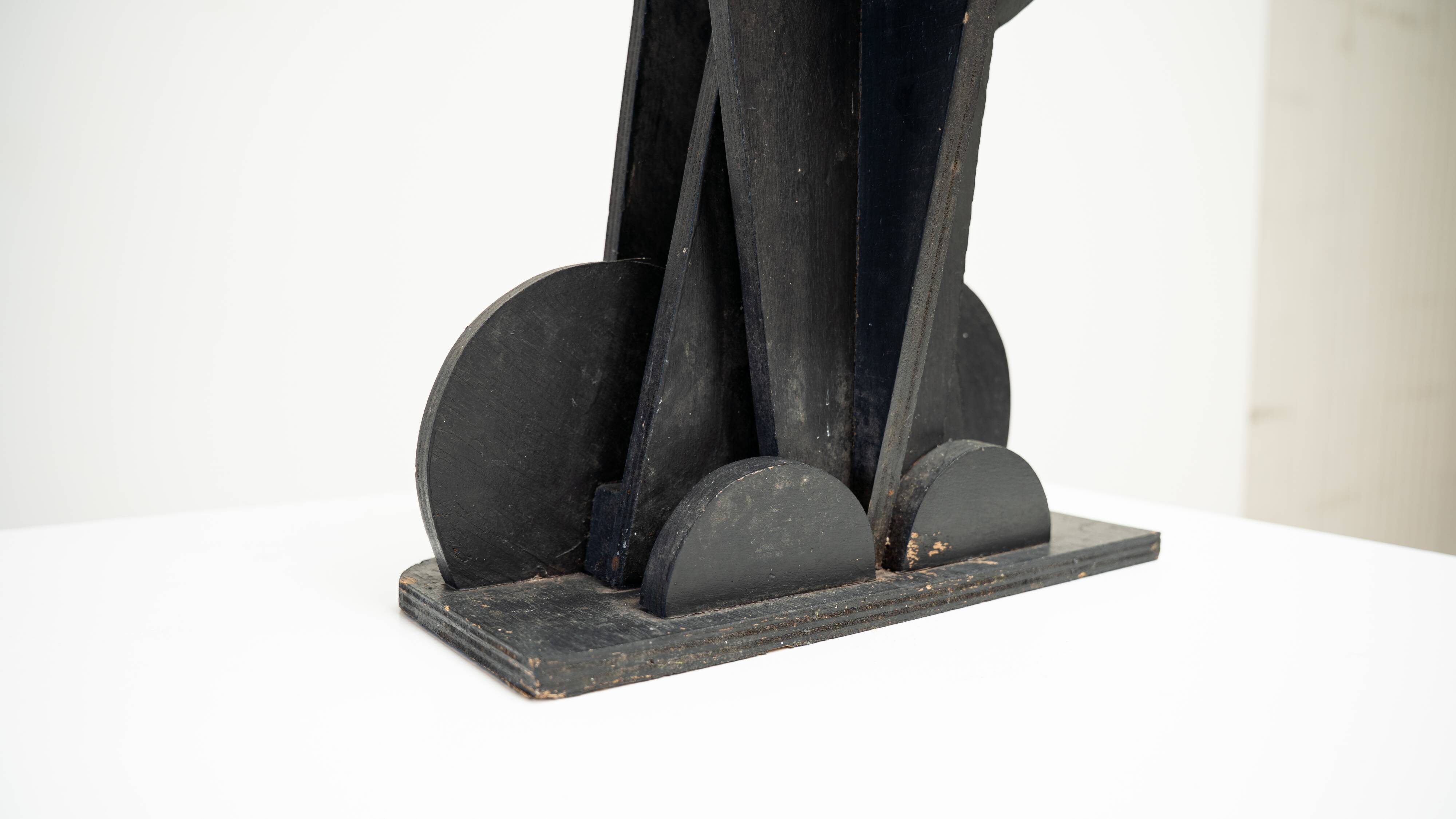 Black brutalist wooden sculpture