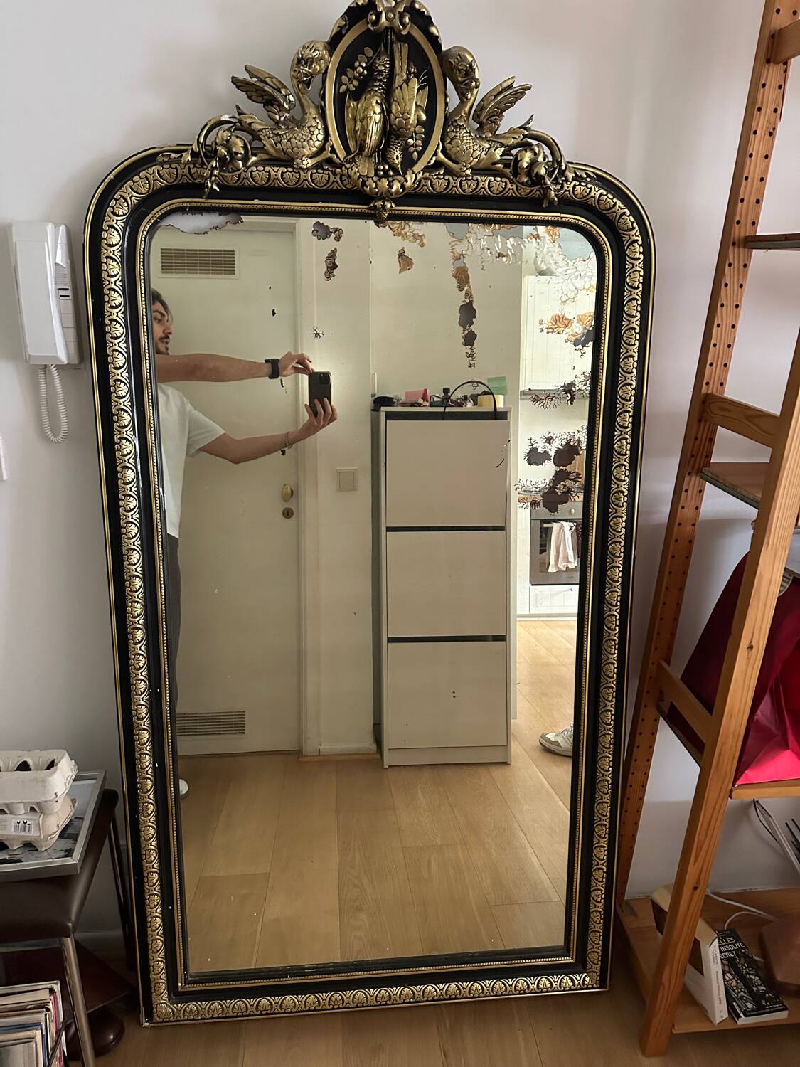Napoleon III mirror with a pediment featuring black and gold dragons and birds.