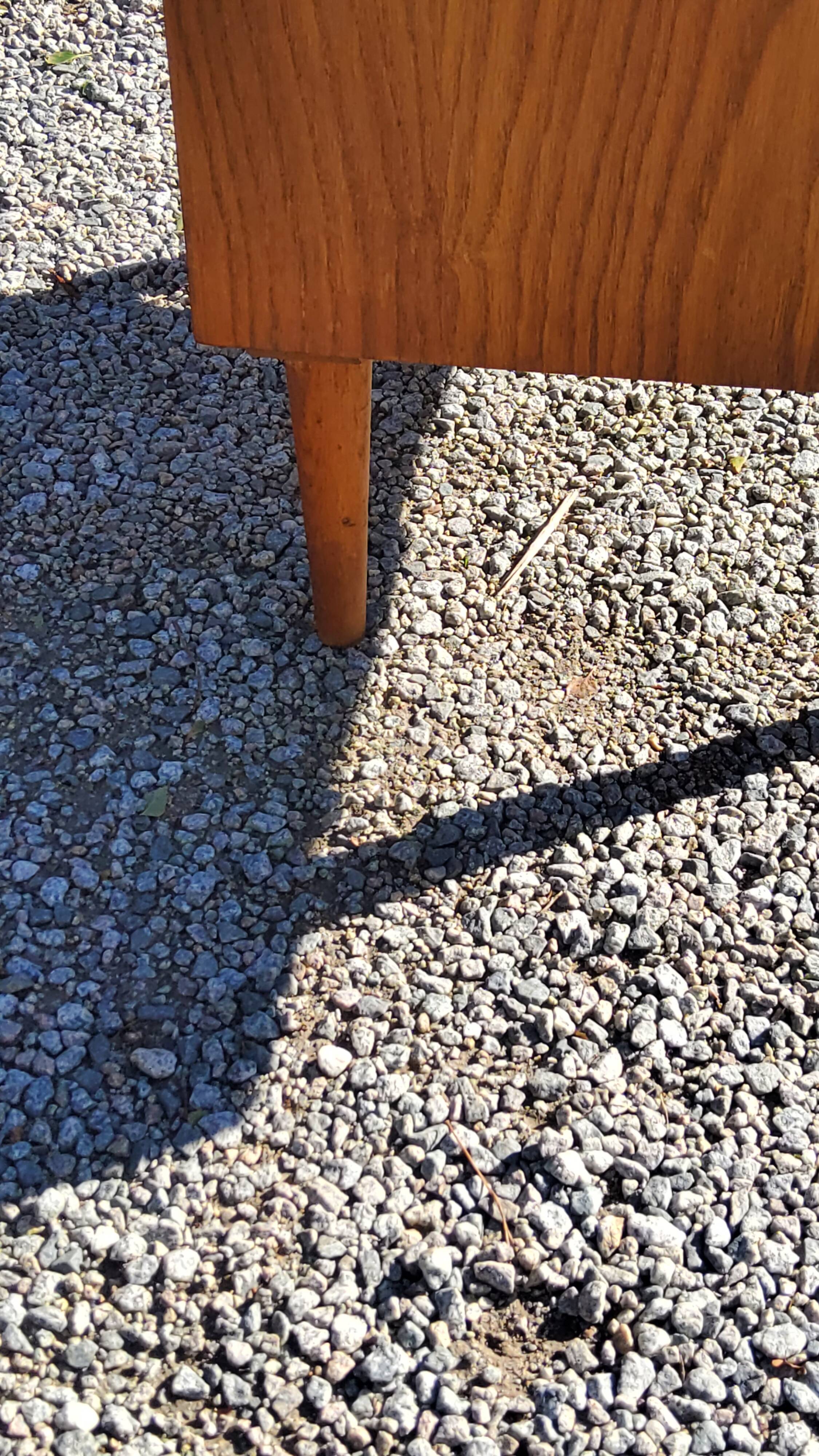 Vintage golden oak sideboard with conical legs from the 1950s
