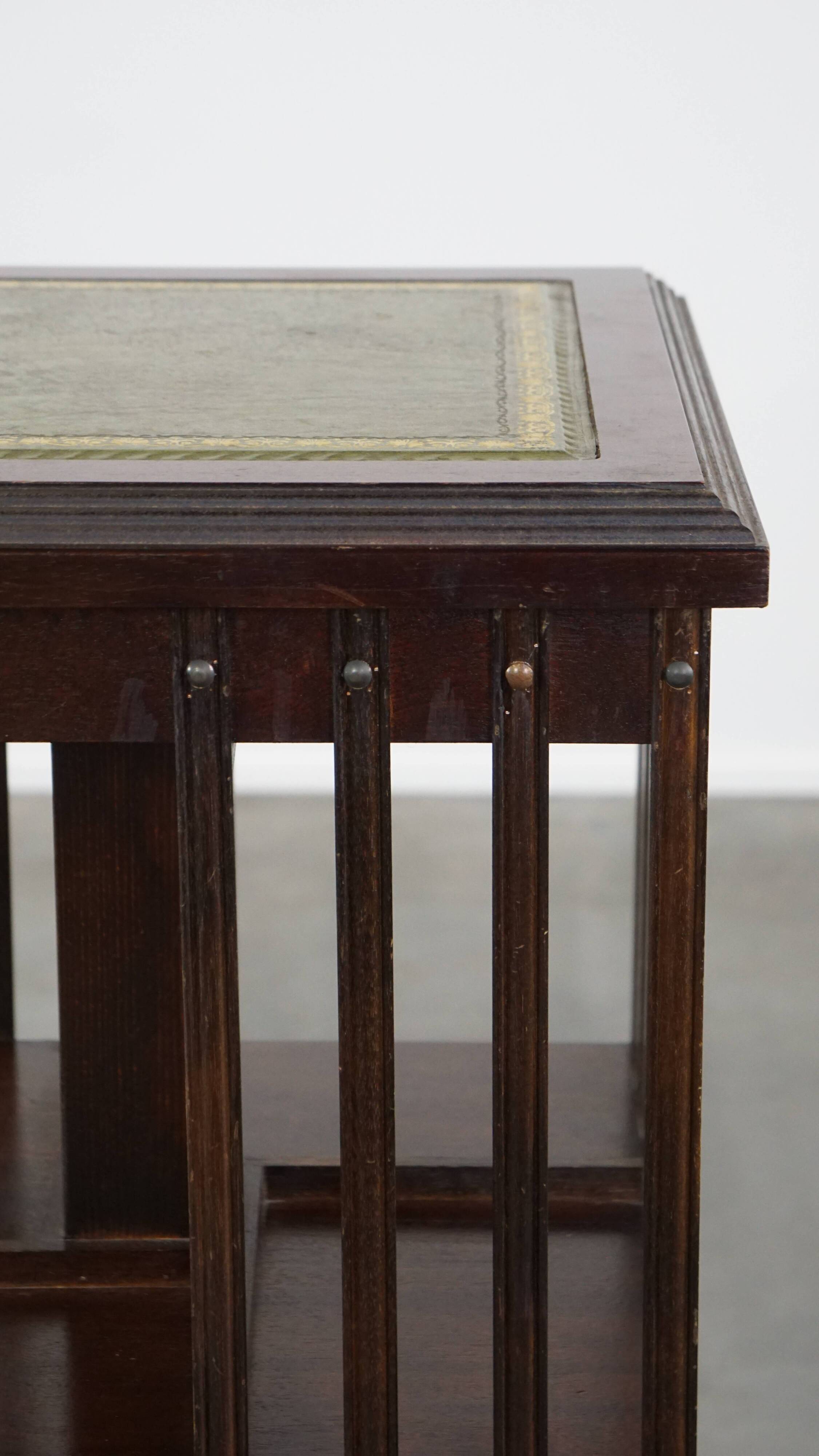 Wooden bookstand with green leather surface and on wheels in English style