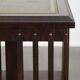 Wooden bookstand with green leather surface and on wheels in English style